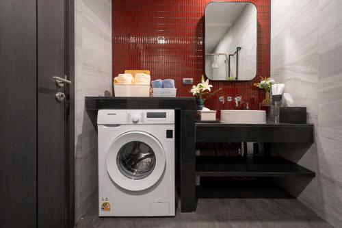 a bathroom with a washing machine and a sink at Vacaystation Edge Central Pattaya in Pattaya Central