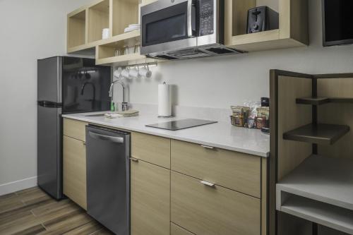 a kitchen with a sink and a refrigerator at TownePlace Suites by Marriott San Antonio Universal City, Live Oak in Selma