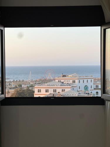 a view of the ocean from a window at Baie d'Alger in Husseïn Dey