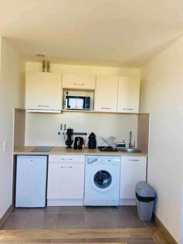 une cuisine avec un lave-linge et un lave-linge dans l'établissement Logement fonctionnel à l'entrée de Bordeaux, à Carbon-Blanc