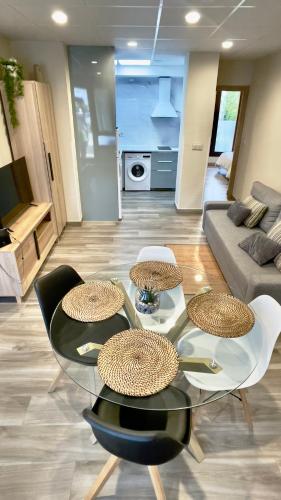 a living room with a glass table and chairs at Lapaserina-A in Arenas de Cabrales
