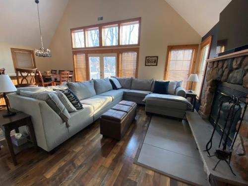 a living room with a couch and a fireplace at Gorgeous House in Camelback Mountain near lifts! in Tannersville
