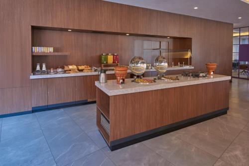 a restaurant with a counter with glasses of wine at City Express Plus by Marriott San Luis Potosi in San Luis Potosí