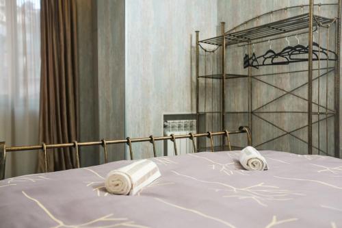 a bedroom with a bed with towels on it at Agmashenebeli Lilu's Apartment 2 in Tbilisi City
