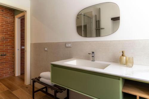 a bathroom with a white sink and a mirror at Sky and Vineyards - Nespolo - in La Morra
