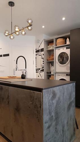 a kitchen with a counter with a sink and a oven at El balconcito al mar in Nerja