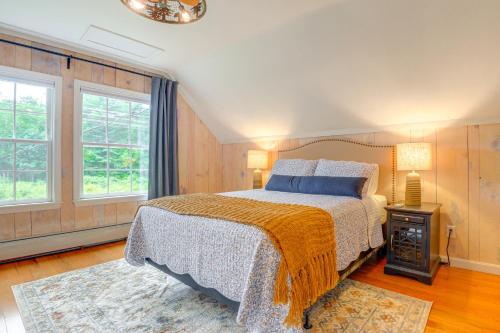 a bedroom with a bed and two windows at Stunning Sterling Sanctuary Unwind on the Water! in Berlin