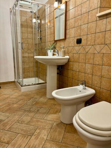 a bathroom with a toilet and a sink and a shower at Verdemare in Acquaviva Picena