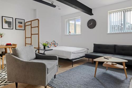 a living room with a bed and a couch at Small Studio Arnold Nottingham in Nottingham