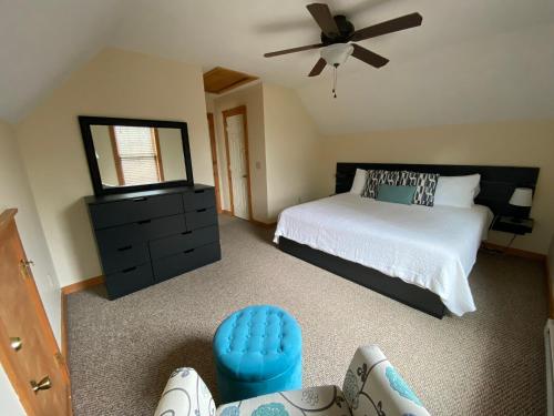 a bedroom with a bed and a black dresser at Gorgeous House in Camelback Mountain near lifts! in Tannersville