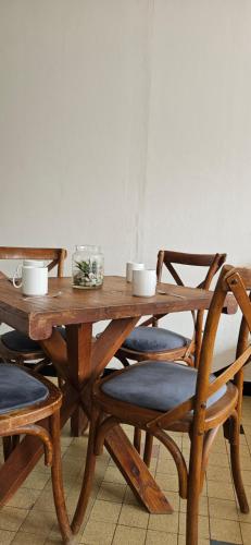 une table en bois avec deux chaises et une table en bois avec des tasses dans l'établissement Roosevelt, à Amiens