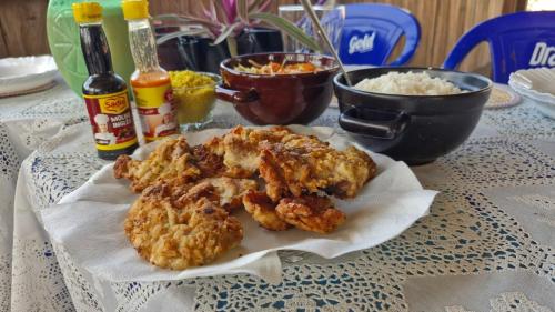 Una mesa con un plato de comida frita y arroz. en Redário Pôr Do Sol - Hospedagem e Experiência no Marajó, en Soure