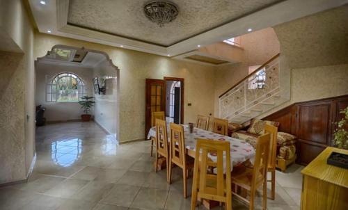 a dining room with a table and chairs at Villa Al Jaouhara in Essaouira