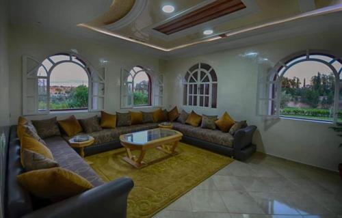 a living room with a couch and a table at Villa Al Jaouhara in Essaouira