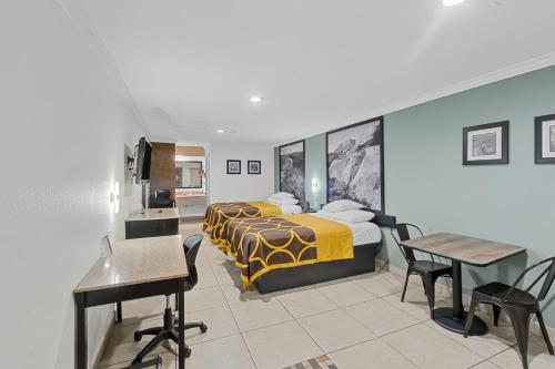 a hotel room with two beds and a desk at Super 8 by Wyndham McAllen-Downtown-Airport-LA Plaza Mall in McAllen