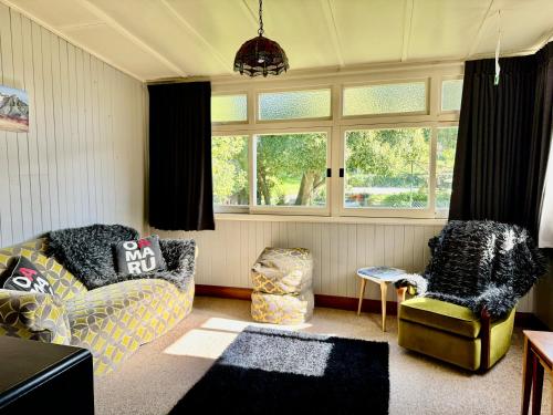 a living room with a couch and a chair at The Italian Warehouse in Oamaru