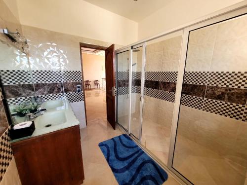 a bathroom with a shower and a sink at Villa Al Jaouhara in Essaouira