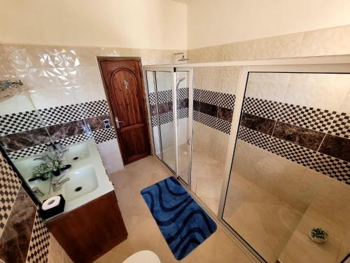 a bathroom with a shower and a sink at Villa Al Jaouhara in Essaouira