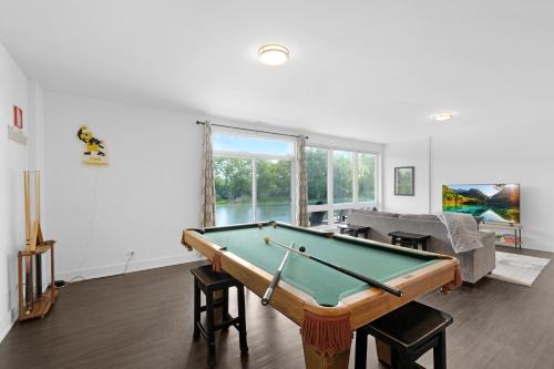 a living room with a pool table in it at Turtle River Retreat in Ottawa