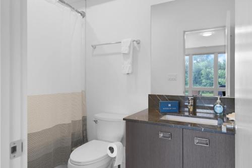 a bathroom with a toilet and a sink and a shower at Turtle River Retreat in Ottawa