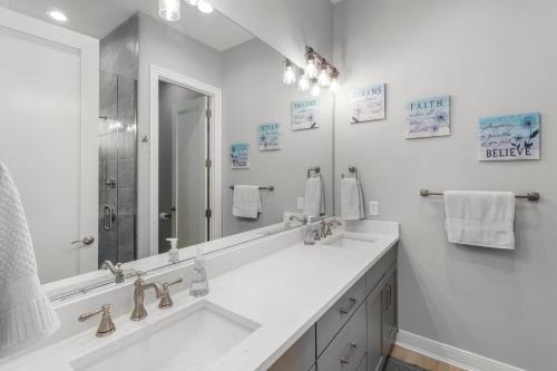 a bathroom with two sinks and a large mirror at Port Place Paradise in Ottawa