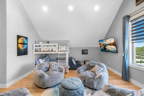 a living room with two chairs and a crib at Port Place Paradise in Ottawa