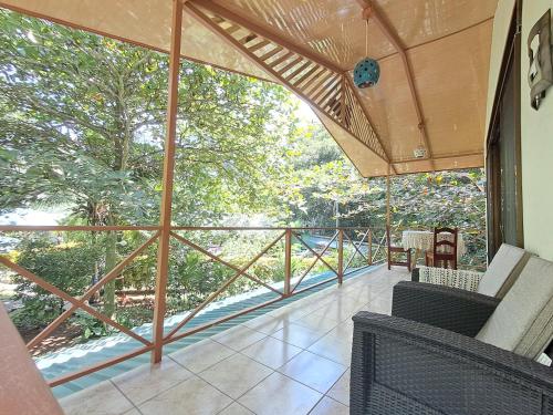 a screened in porch with a view of the trees at New Caribe Point in Cahuita