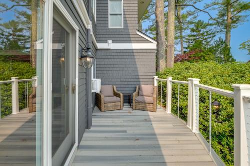 a porch of a house with two chairs on it at The Beachhouse Retreat with Prescot Bay Views! in Stockton Springs