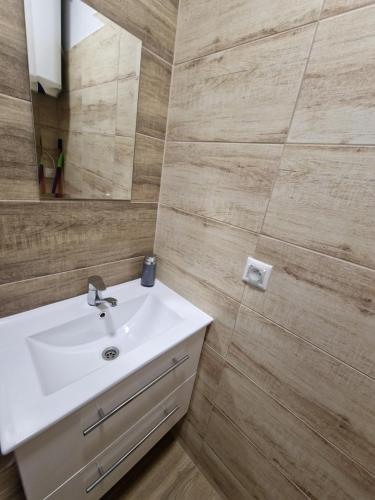 a bathroom with a white sink and a mirror at Ubytovanie Čereňany in Čereňany