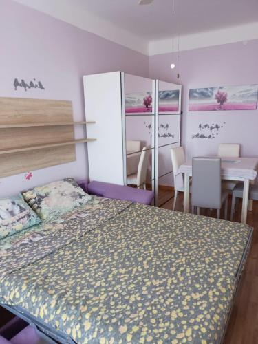 a bedroom with a bed and a table and chairs at Orizzonti in Trieste
