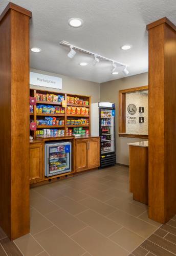 a grocery store aisle with refrigerators and a refrigerator at Comfort Suites Hartville-North Canton in Uniontown