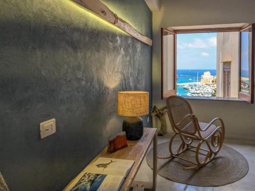 a room with a table and a chair and a window at Terrammare del Golfo in Castellammare del Golfo