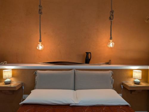 a couch with two pillows in a room with lights at Terrammare del Golfo in Castellammare del Golfo