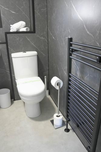 a bathroom with a white toilet in a room at Ten Acres House in Sauchie
