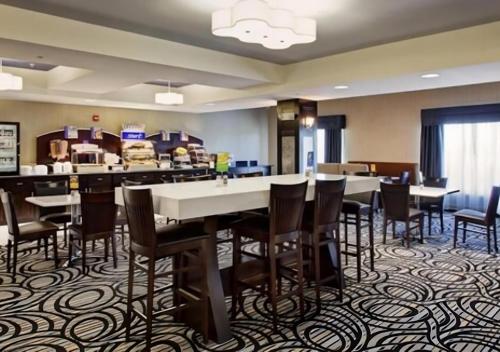 a restaurant with tables and chairs in a room at Holiday Inn Express & Suites North Fremont by IHG in Fremont
