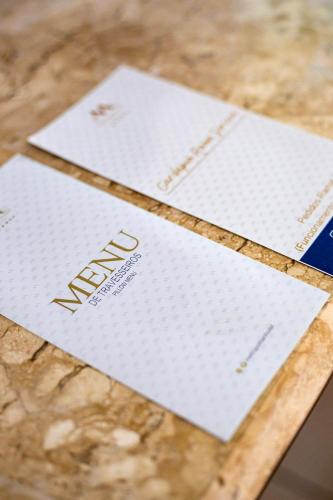 two white envelopes sitting on top of a table at Metropolitan Hotel in Teresina