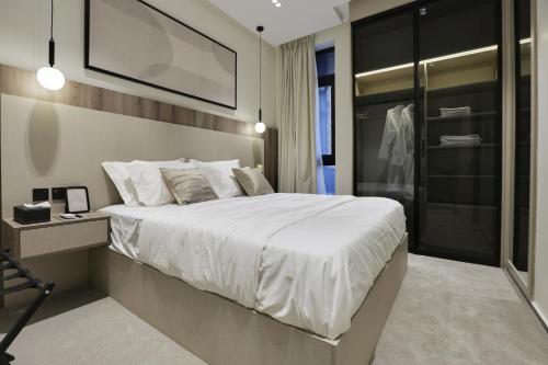 a bedroom with a large white bed and a desk at شقة بغرفة نوم واحدة بطابع فندقي in Riyadh