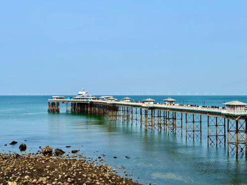 a pier in the water with houses on it at Llandudno Boutique style seaside retreat with stunning views in Llandrillo-yn-Rhôs
