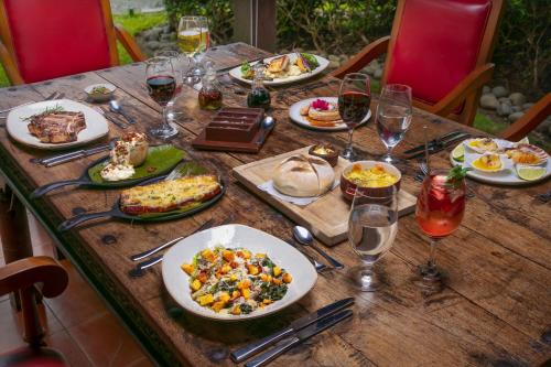 a wooden table with plates of food and glasses of wine at JW Marriott Guanacaste Resort & Spa in Tamarindo