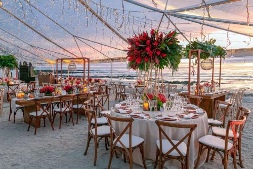 a wedding reception on the beach with tables and chairs at JW Marriott Guanacaste Resort & Spa in Tamarindo