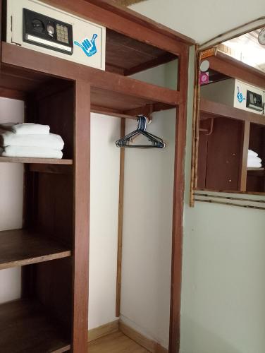 a room with a bunk bed with a shelf at Mal Pais Surf Camp in Santa Teresa Beach