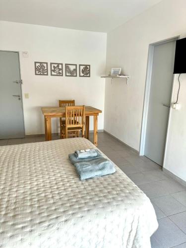 a bedroom with a bed and a table and a table at Cid Movistar Arena in Buenos Aires