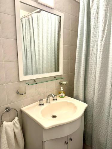 a bathroom with a sink and a mirror at Cid Movistar Arena in Buenos Aires