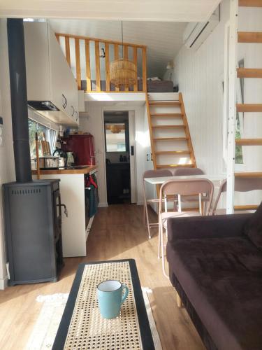 a living room with a couch and a spiral staircase at Pausa in Żegoty