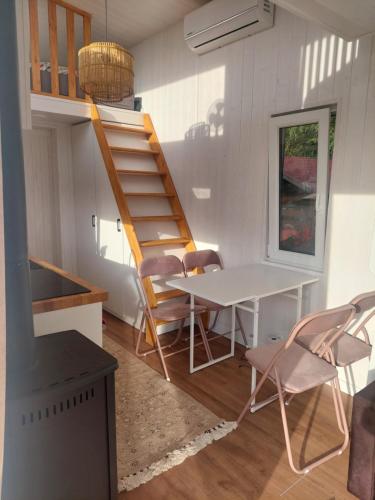 a room with a staircase and a table and chairs at Pausa in Żegoty