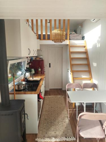 a kitchen with a staircase and a table with chairs at Pausa in Żegoty