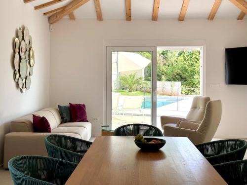 a living room with a table and chairs at Villa Lula, Pool, Sauna, 6 Personen, 3 Bäder in Dobreć