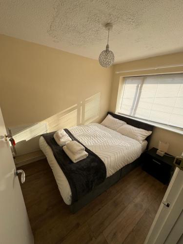 a bedroom with a bed with two towels on it at Amirs house reed ave in Kent