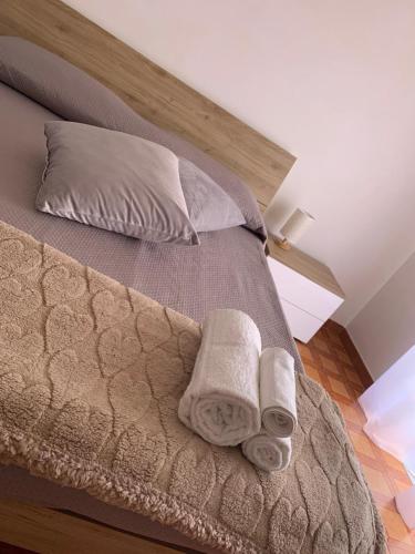 a bedroom with a bed with two towels on it at Affittacamere da Anna in Pozzilli