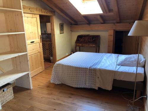 une chambre avec un lit dans une pièce en bois dans l'établissement Appartement de standing en Savoie, à Notre-Dame-de-Bellecombe